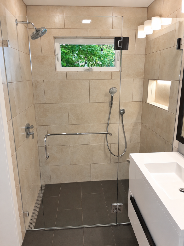 Bathroom remodel with glass shower and vanity completed by Earth Smart Building and Remodeling