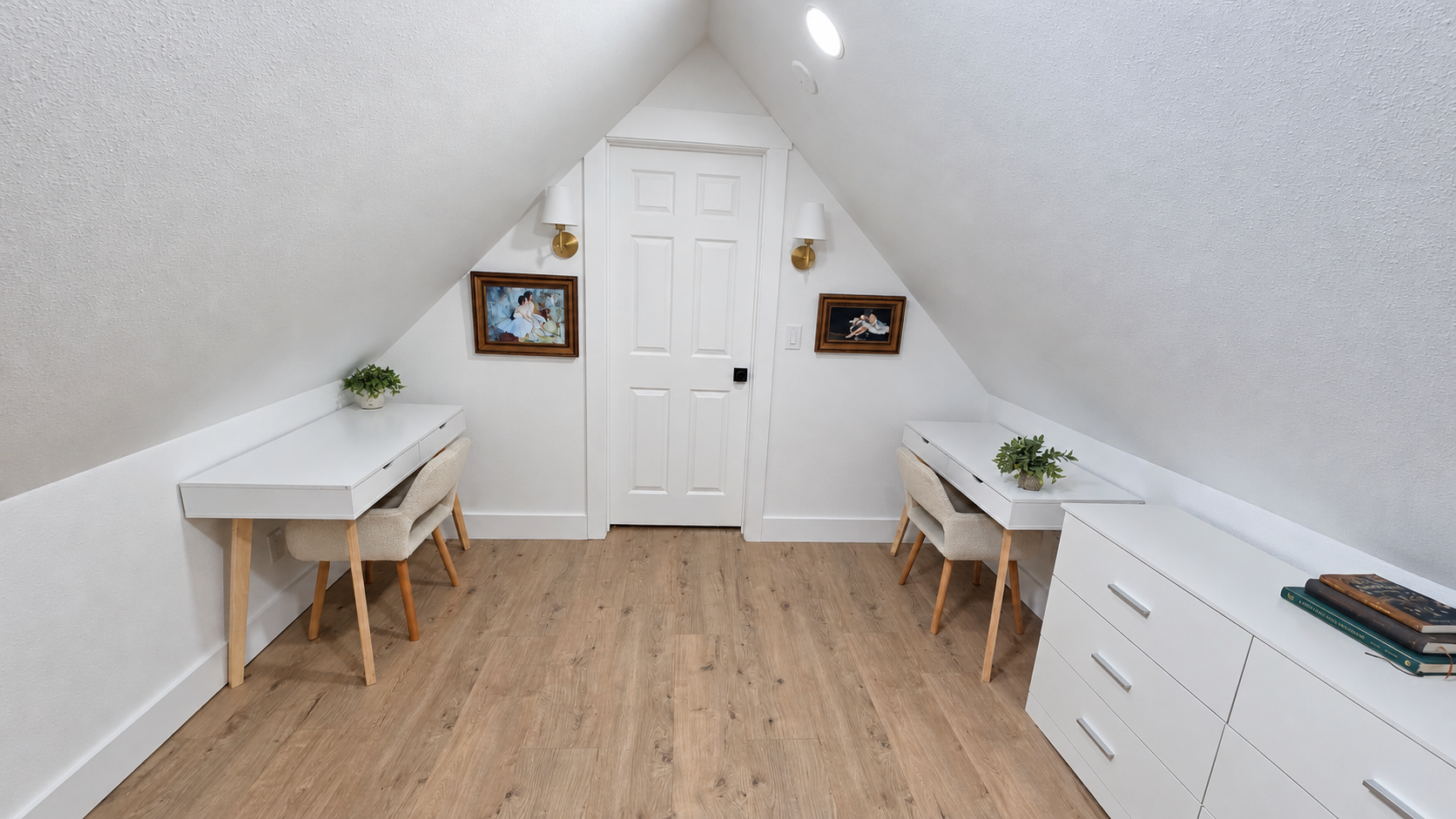 Finished loft room with white door casing, baseboards and wood-look flooring